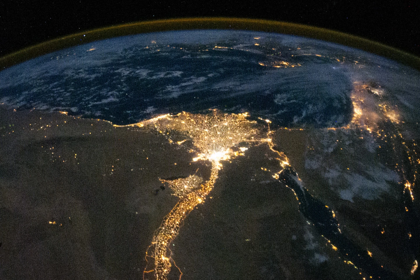 City lights tracing the Nile Valley and Delta beneath the atmosphere, photographed from the International Space Station